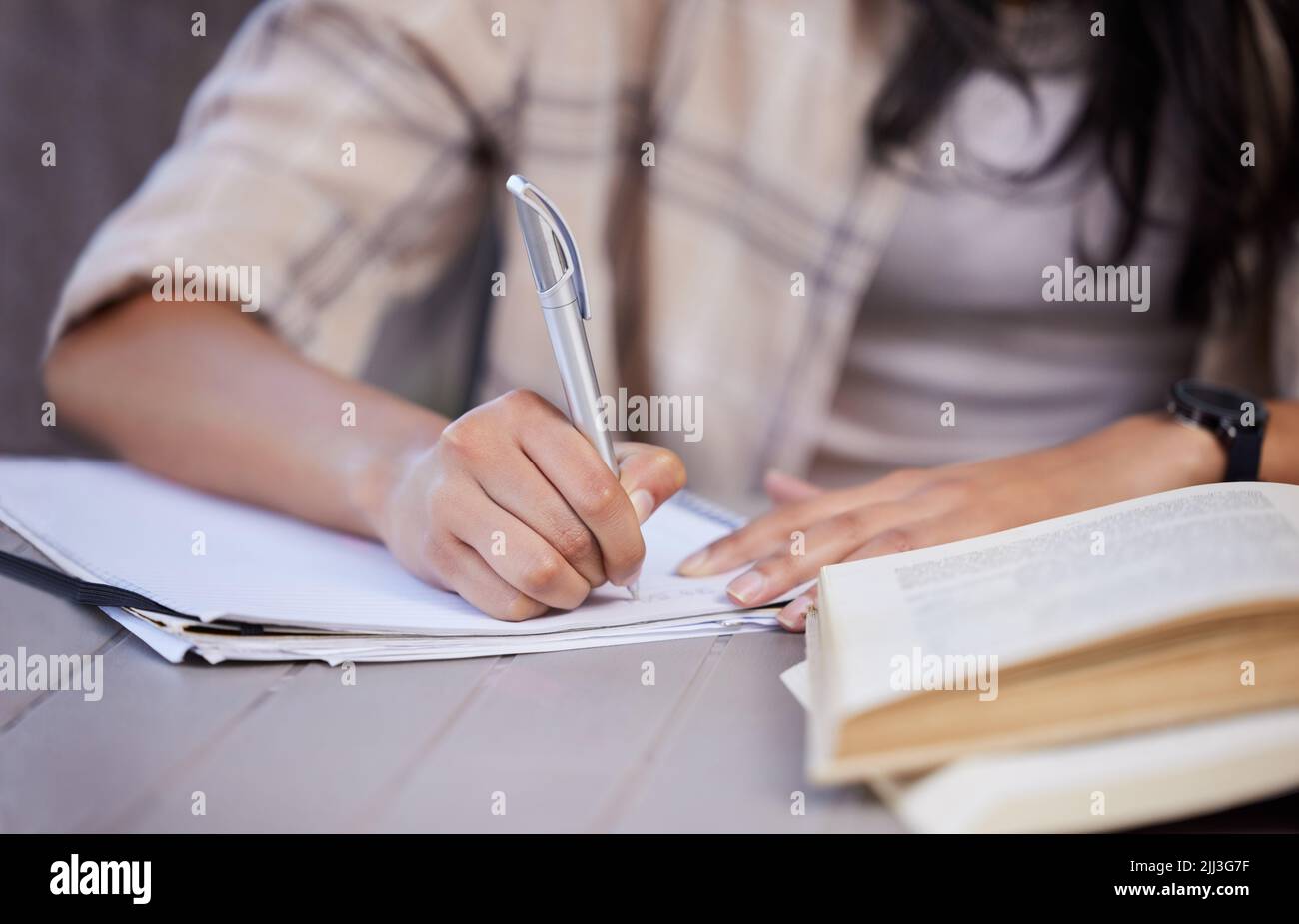 Working out my steps going forward. an unrecognizable student studying at home. Stock Photo