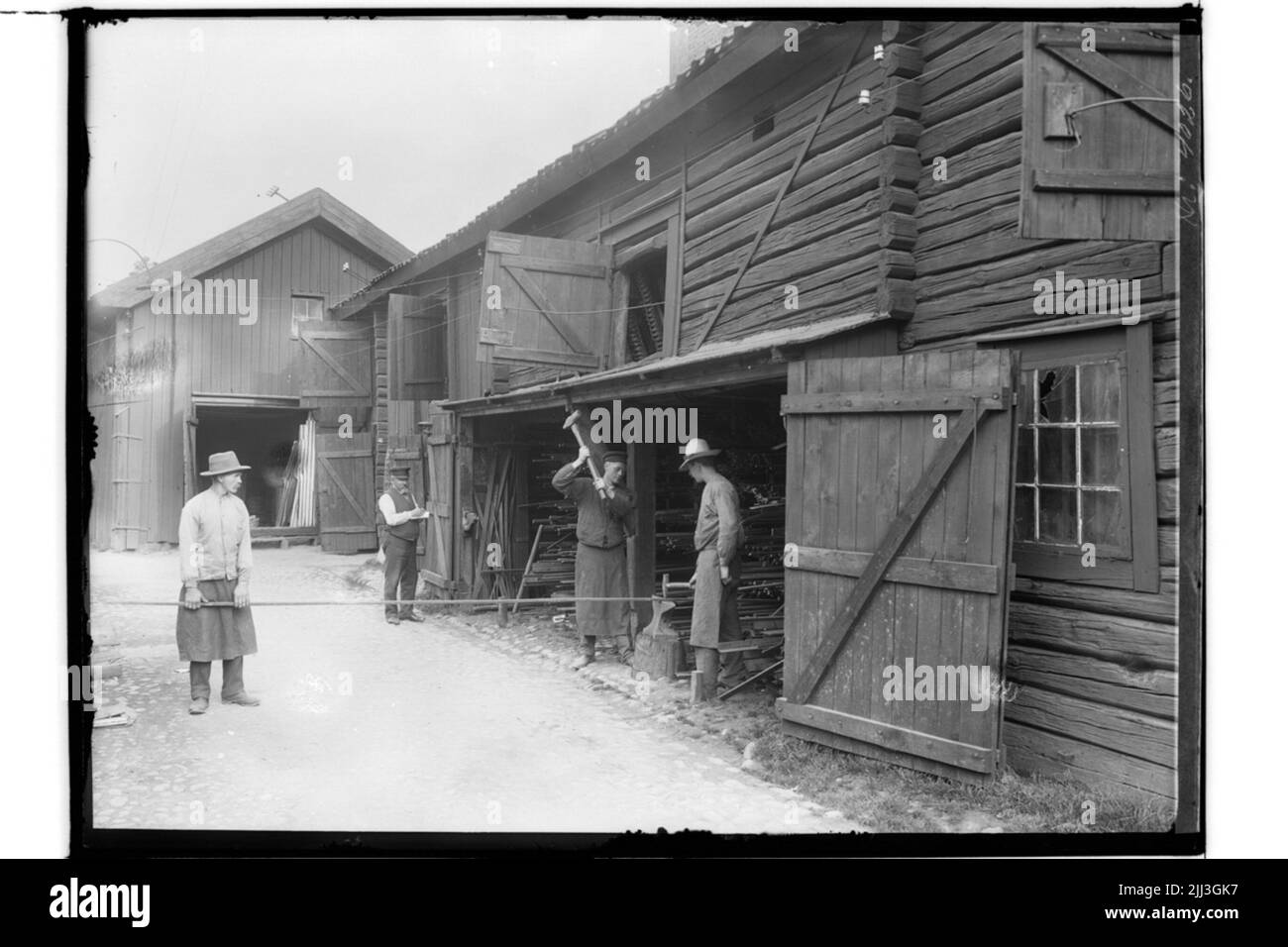 P.O. Jonsson's hardware store, magazine buildings in lying timber. Four