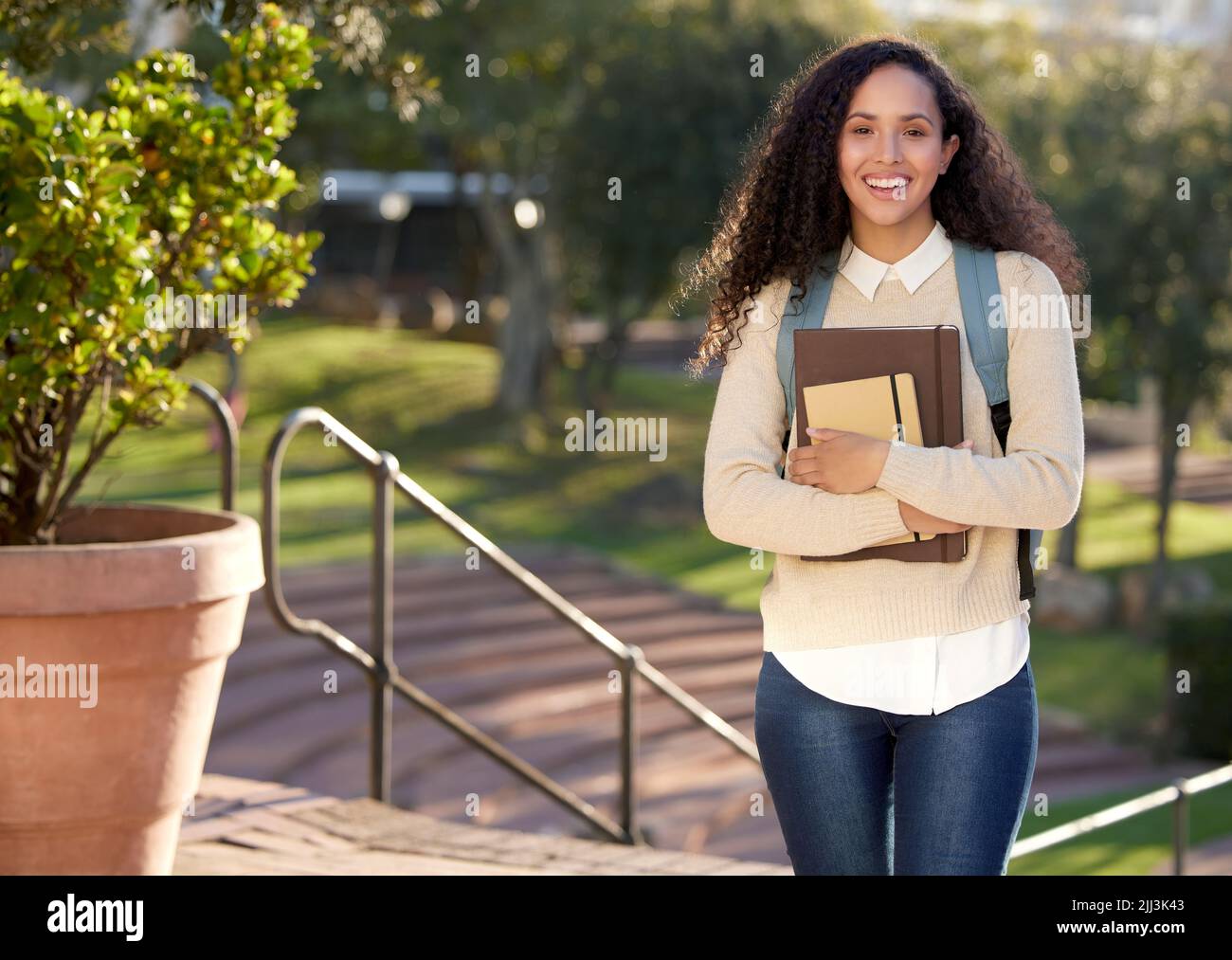 A taste of being an adult. Portrait of an attractive young female student standing outside on campus. Stock Photo