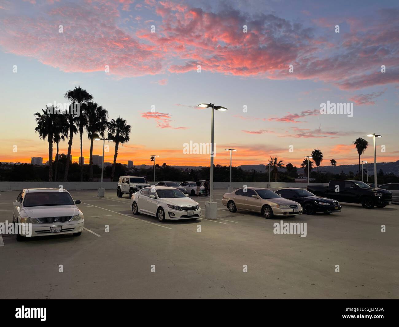 Rooftop parking lot with colorful sunset in Los Angeles, CA Stock Photo