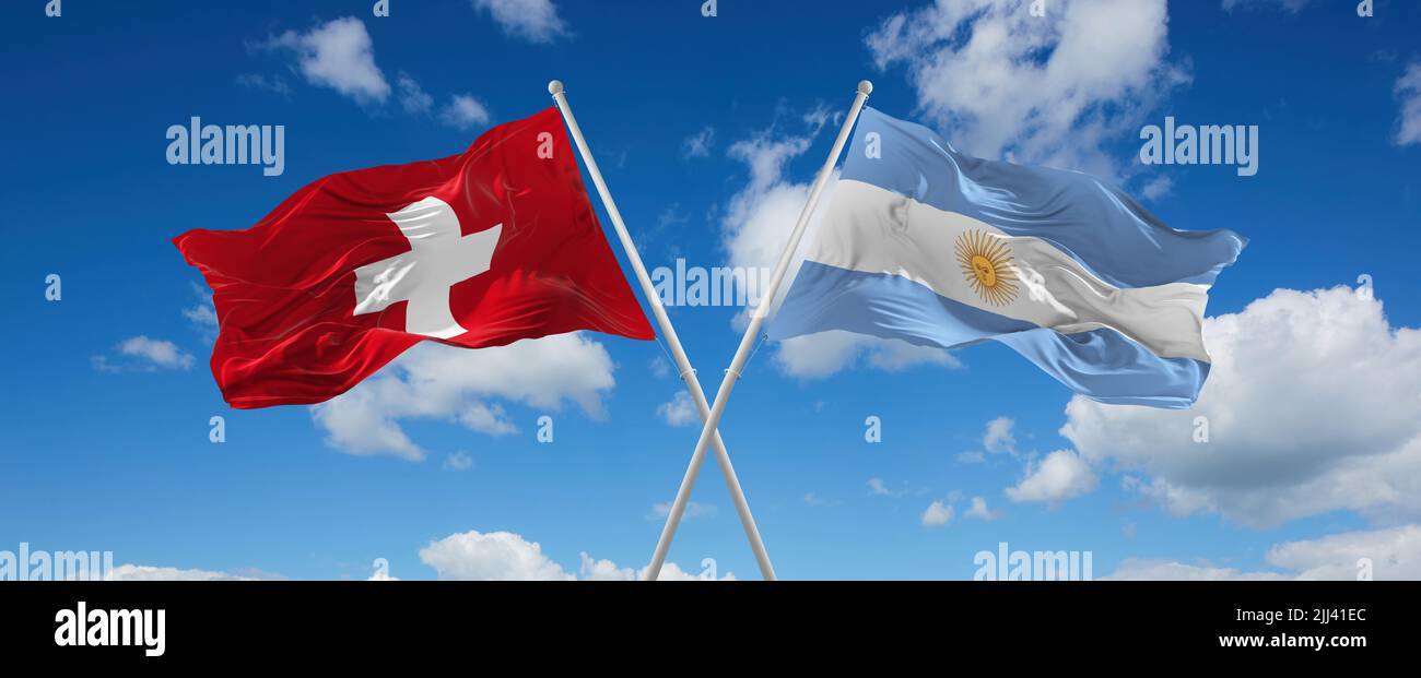 two crossed flags Argentina and Switzerland waving in wind at cloudy ...