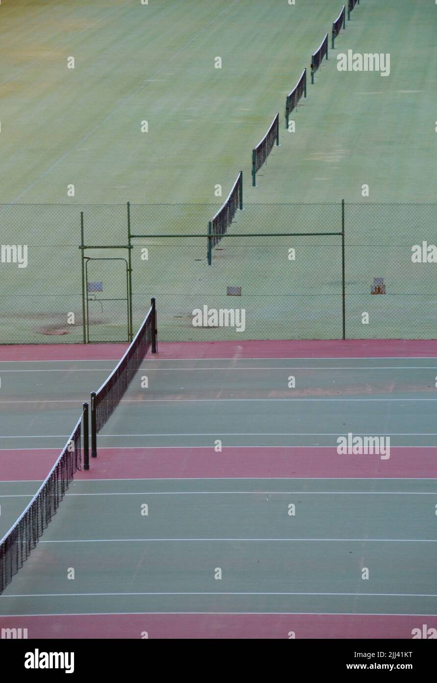 Grass and hard surface tennis courts from a high angle in Mildura with nets in a line Stock Photo