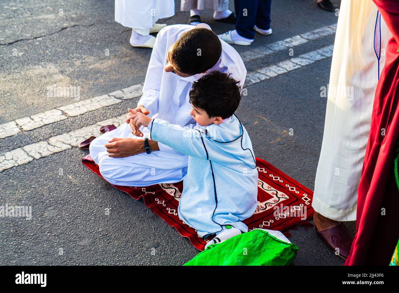 Marrakech, Morocco - 10 July 2022 : A father and his kid during the prayer of Aid Al Adha 2022 in Marrakech, Morocco Stock Photo