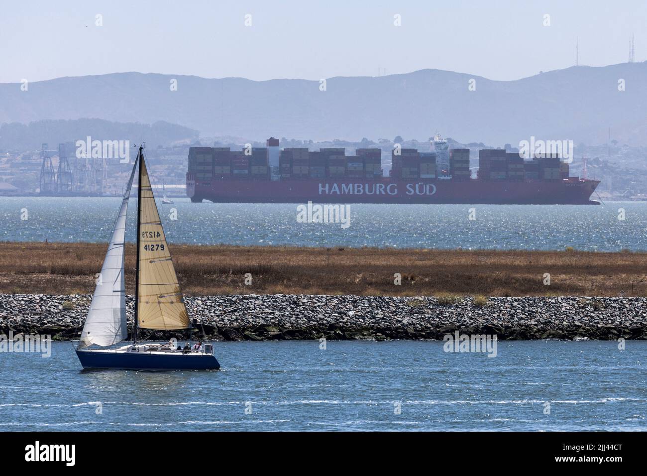 A cargo ship is seen near the port of Oakland as independent truck driver continue protesting against California's new law known as AB5, in Oakland, California, U.S., July 22, 2022. REUTERS/Carlos Barria Stock Photo