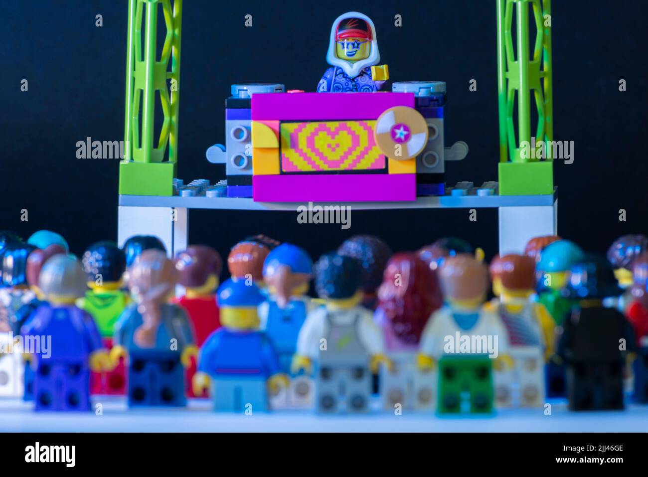 Lego DJ minifigure performing a show on stage with thousands of