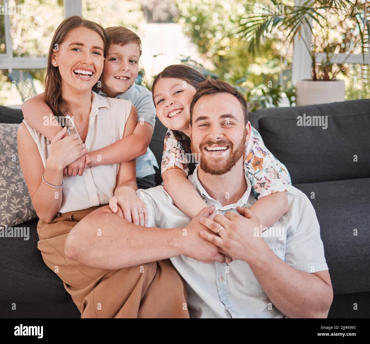 Lay it back. a young family happily bonding together on the sofa at home. Stock Photo