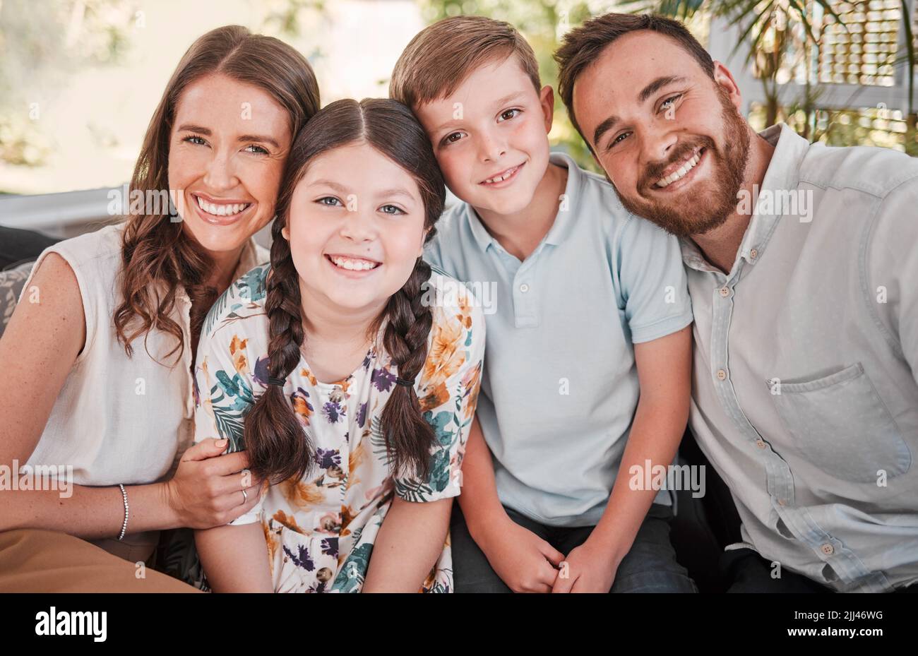 Activate your joy. a young family happily bonding together on the sofa at home. Stock Photo