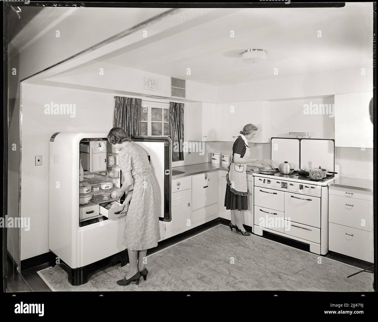 Housewives using modern kitchen appliances for advertisement in the 1940s. Image from 8x10 inch negative. Stock Photo