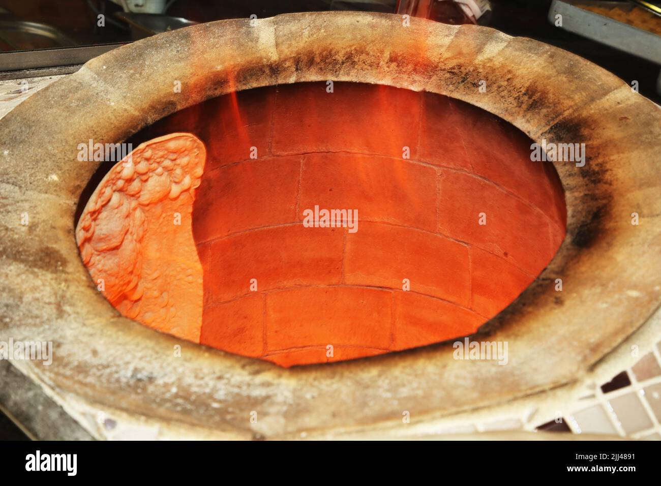 Turkish pita bread in tandoor (clay oven) in Istanbul Turkey. Stock Photo