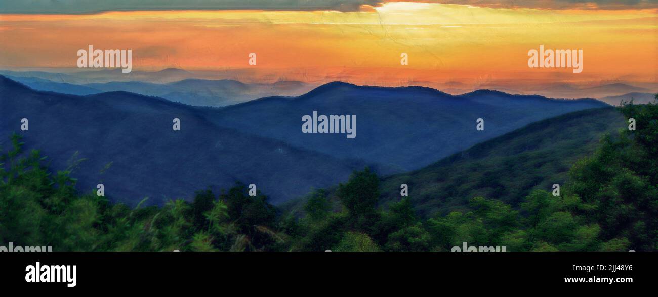 Sunrise over Shenandoah National Park, with mountains in silhouette and the sky a golden orange. Stock Photo