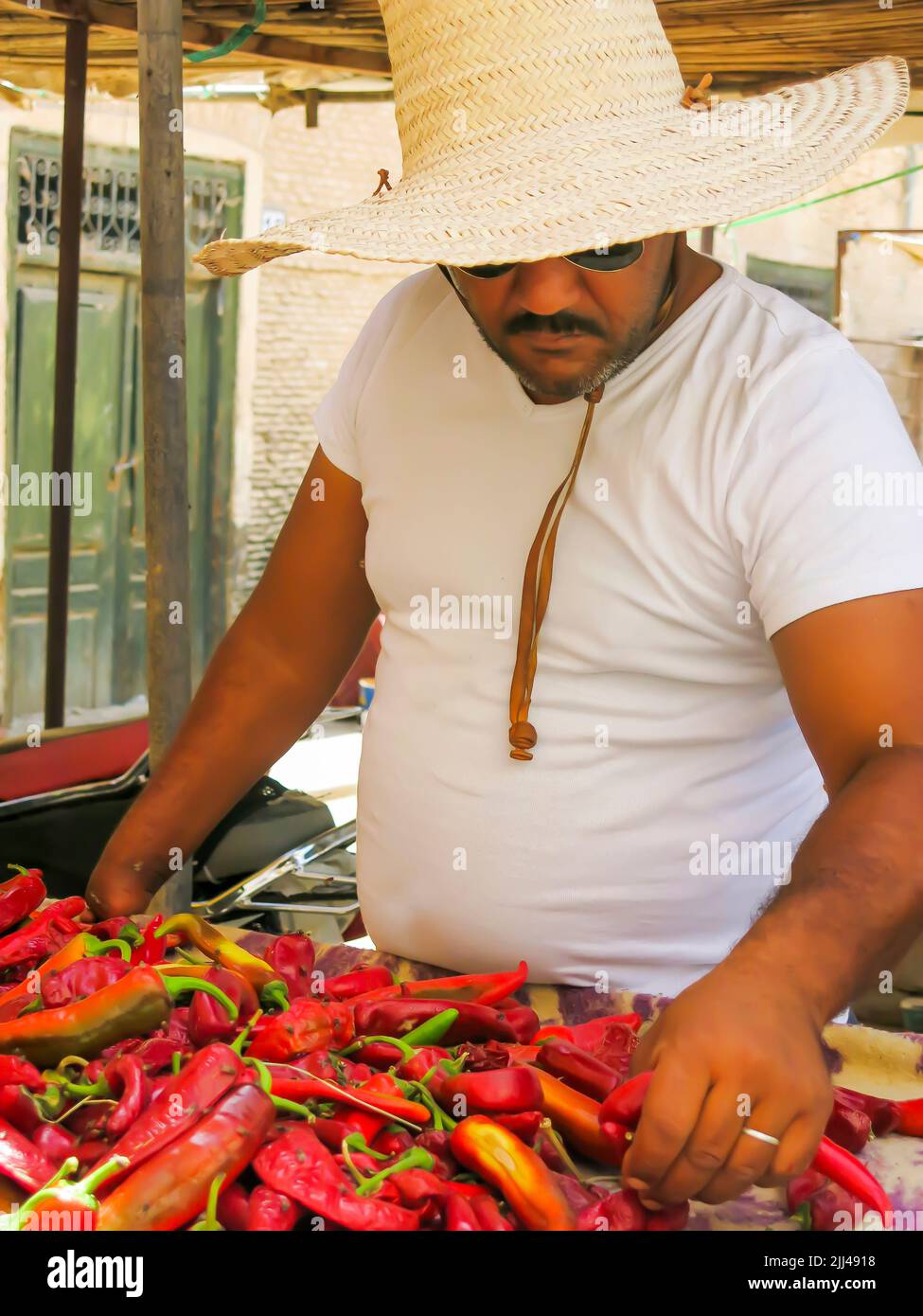 Market Vendor Selling Peppers Stock Photo