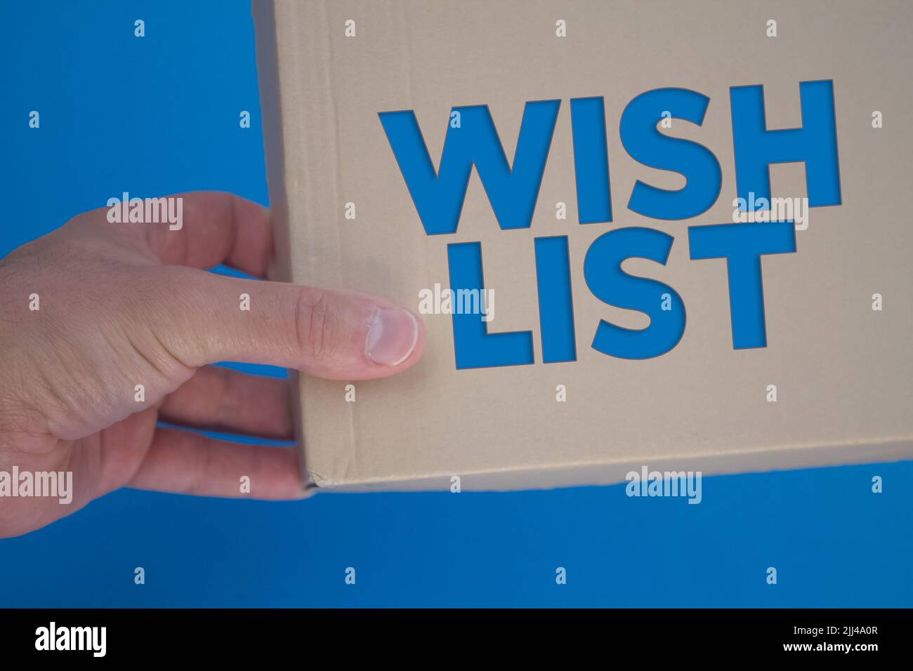 Wish List word with cardboard box. Brown folded cardbox. Stock Photo