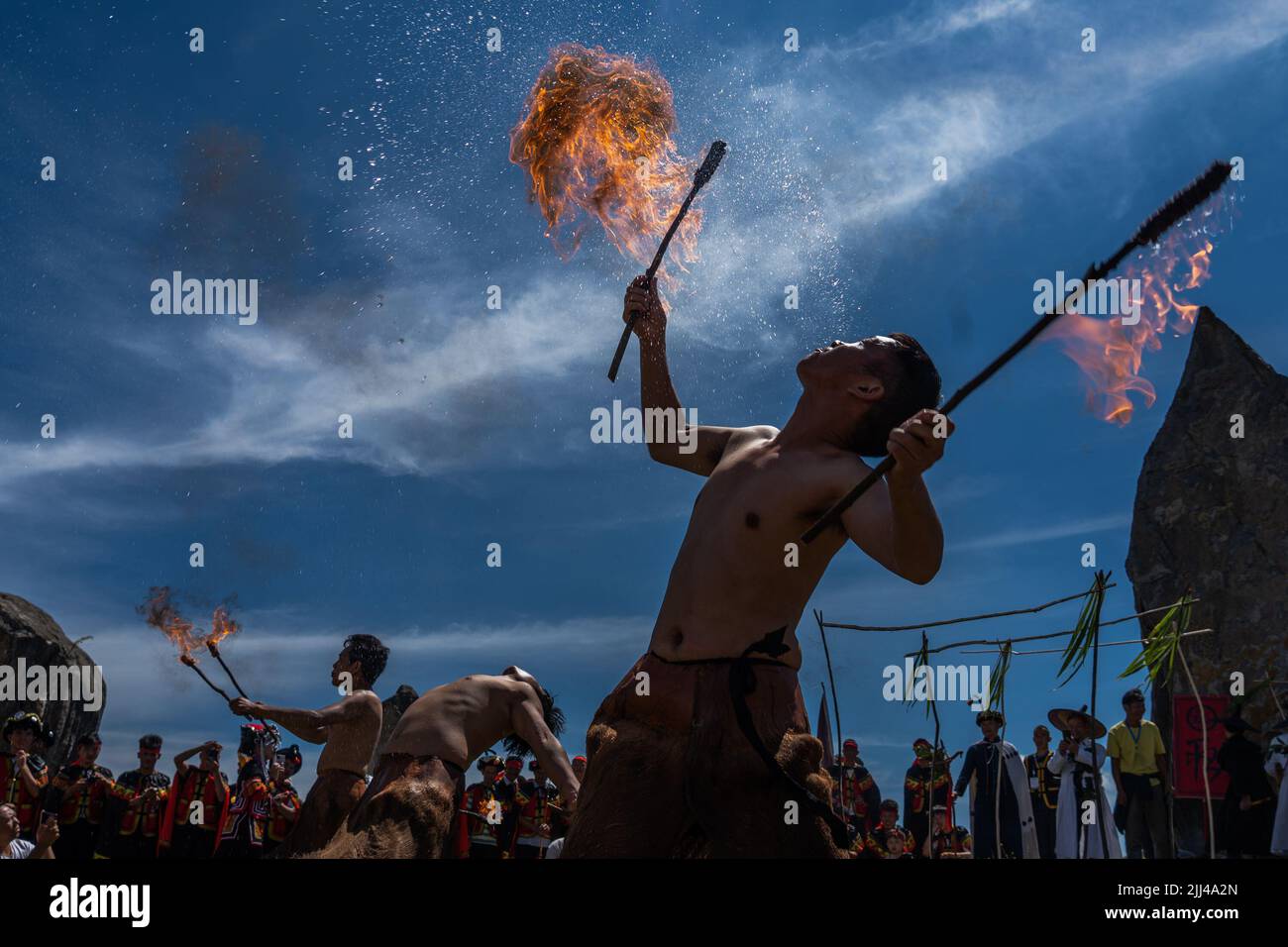 BIJIE, CHINA - JULY 22, 2022 - People of the Yi ethnic group take part in a fire lighting ceremony during the Torch Festival at Baili Azalea Managemen Stock Photo