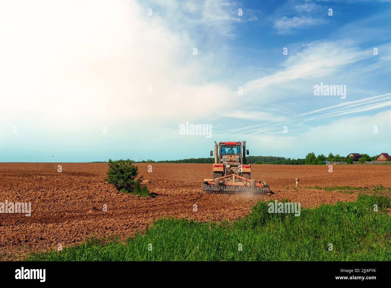 The tractor plows the land. Preparation for sowing and planting