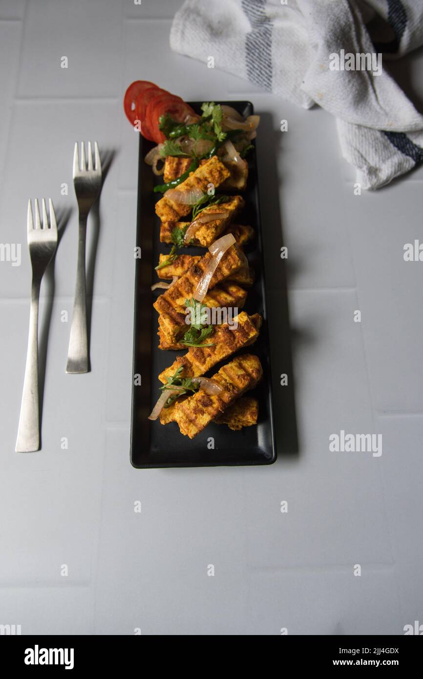 Grilled paneer or cottage cheese cubes with use of selective focus Stock Photo