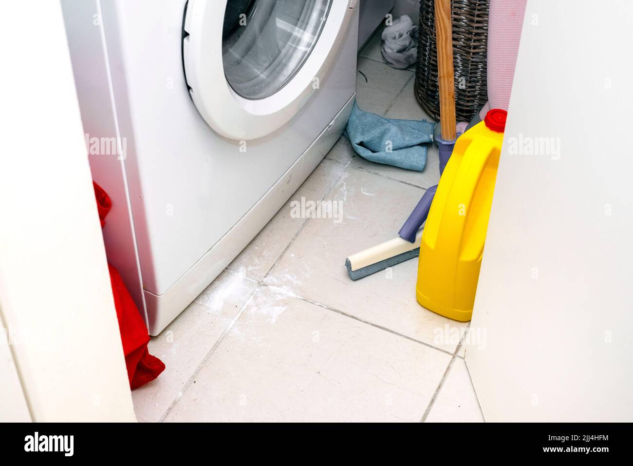 messy bathroom with spilled washing powder on the floor Stock Photo