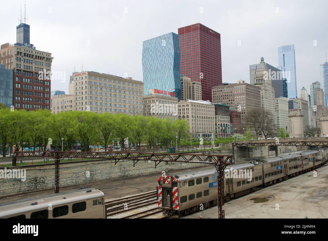 CHICAGO, ILLINOIS, UNITED STATES - MAY 12, 2018: Tracks with switches and trains in downtown Chicago's Grant Park with the skyline in the background Stock Photo