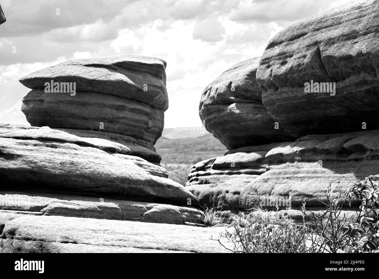 Rounded weathered Quartzite boulders in the Magaliesberg Mountains South Africa in black and white Stock Photo