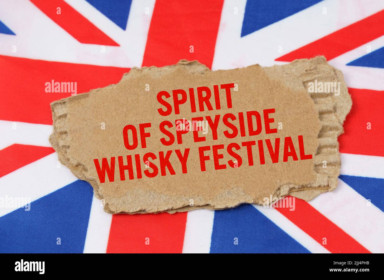 Holidays of the UK. Against the background of the flag of Great Britain lies cardboard with the inscription - Spirit of Speyside Whisky Festival Stock Photo