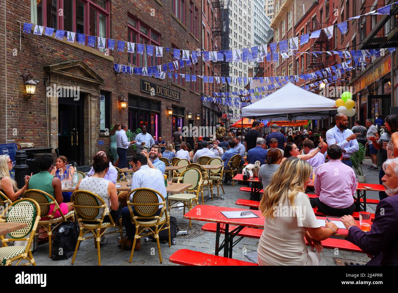 Office workers after work at Stone Street with its many restaurants, outdoor dining, and beer garden in Lower Manhattan's Financial District, New York Stock Photo