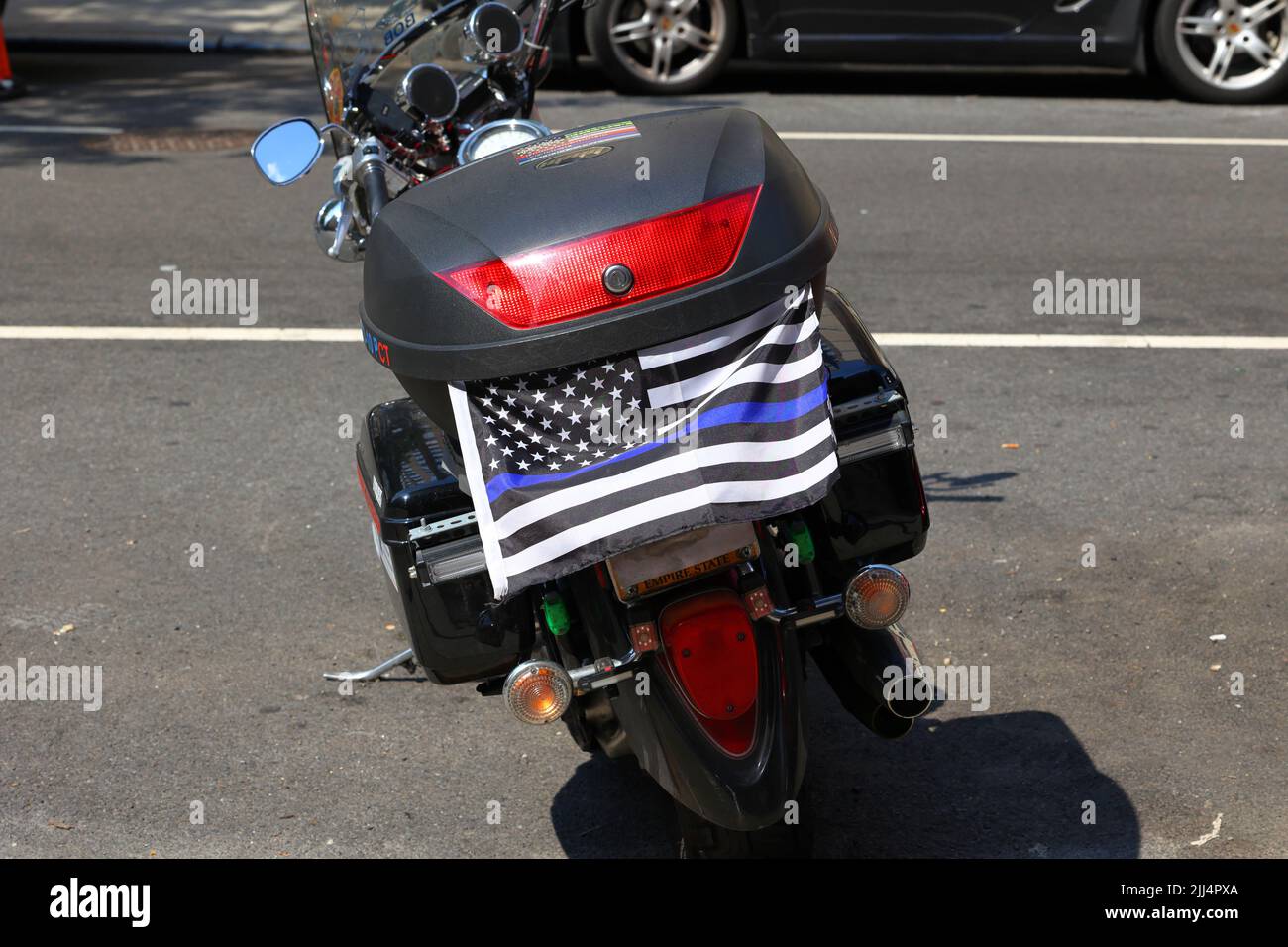 A Thin Blue Line 'Blue Lives Matter' flag on a motorcycle with an obstructed, obscured license plate. New York, July 20, 2022. Stock Photo