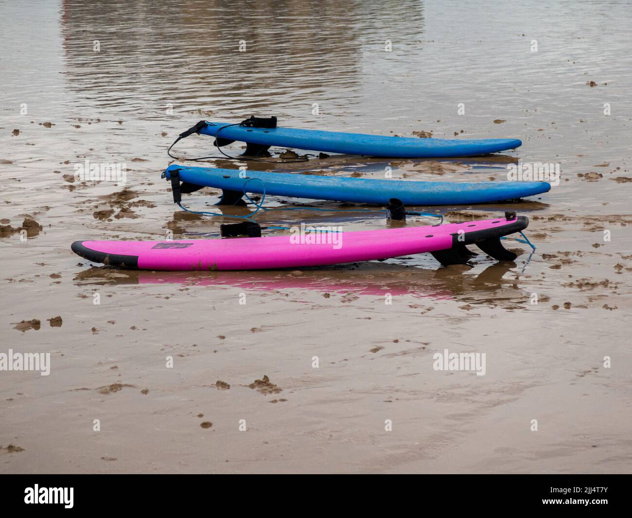 surfboards on the beach sand on a cloudy day Stock Photo Alamy