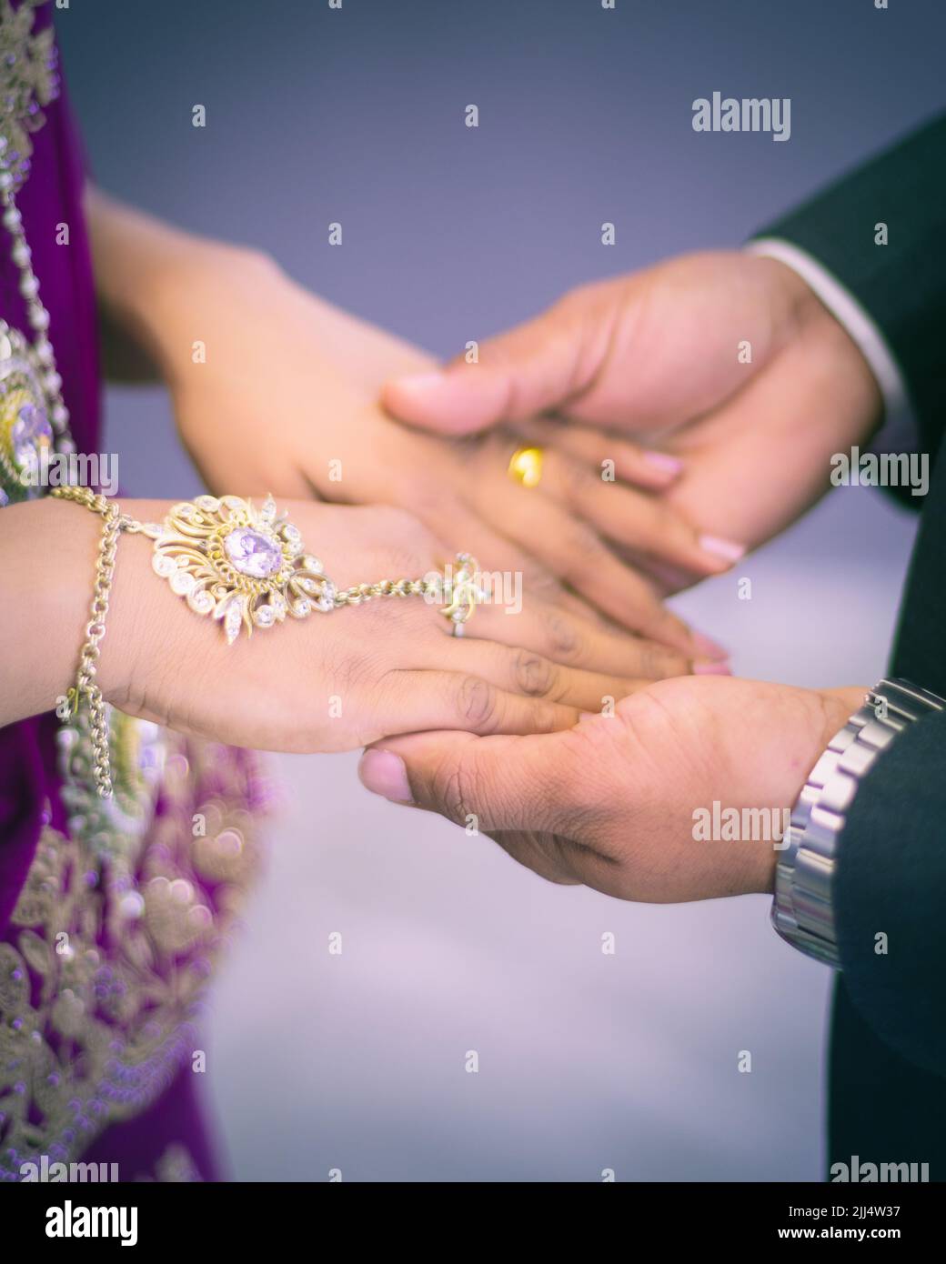 Newlyweds hands, groom holding bride's hands. Concept of the beginning of the new journey. Stock Photo