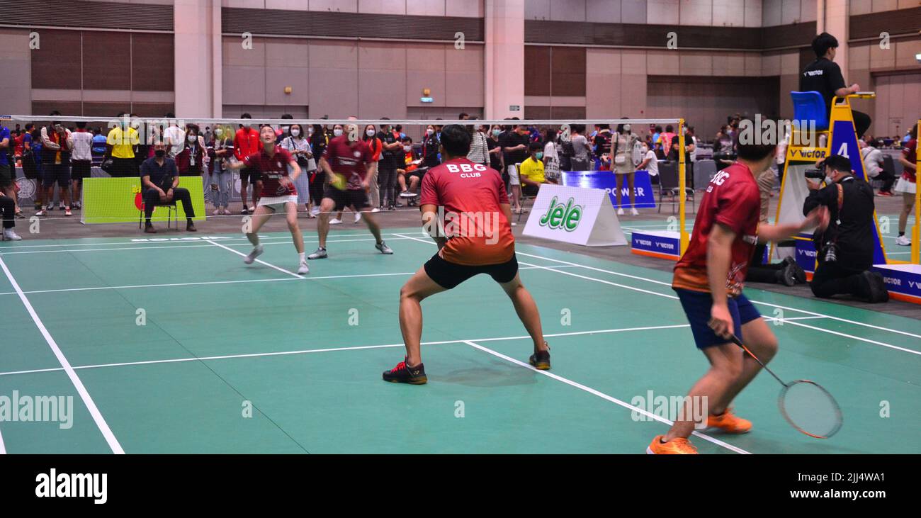 July 23rd, 2022. Khemanit Jamikorn, (playing badminton at left) usually known as 'Pancake' (Thai: เขมนิจ จามิกรณ์),  is a Thai TV actress, singer and model. She won Thai Supermodel Contest 2004 and later won Model of the World 2004 in China. Her husband plays beside her on the right with another two players in the foreground. The event is the table tennis and badminton sports event 'BBG Princess Cup 2022' where participants compete to win the trophy of Her Royal Highness Princess Maha Chakri Sirindhorn at Royal Paragon Hall, Siam Paragon Shopping Center, Bangkok, Thailand, Asia. Stock Photo