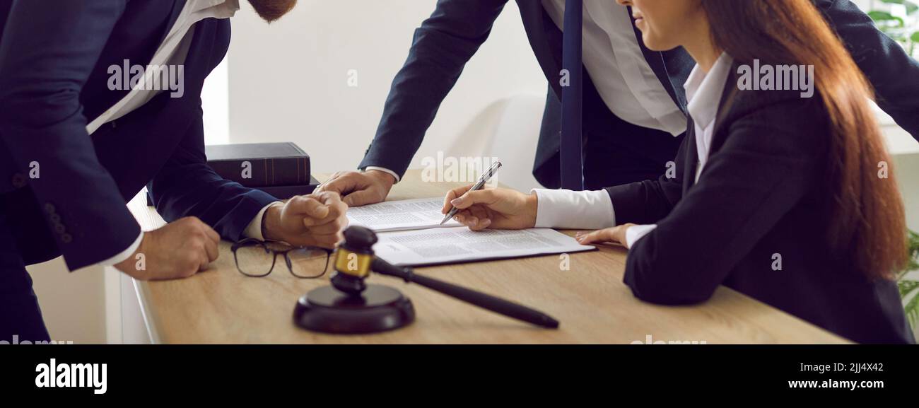 Team of lawyers working with documents and signing contracts and notary agreements Stock Photo