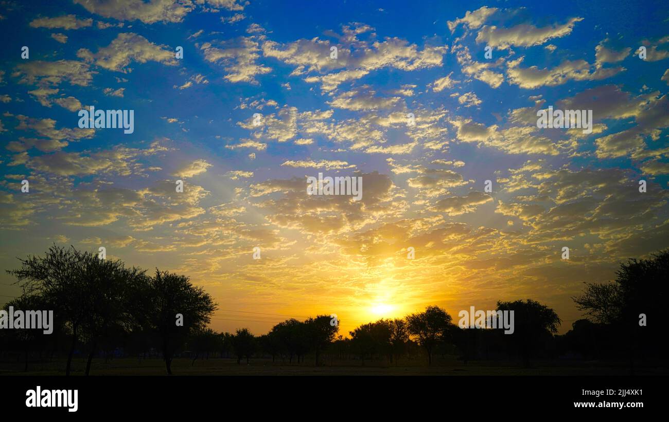 Dramatic cloudy sunset or dawn sky. Beautiful yellow evening shot. Stock Photo