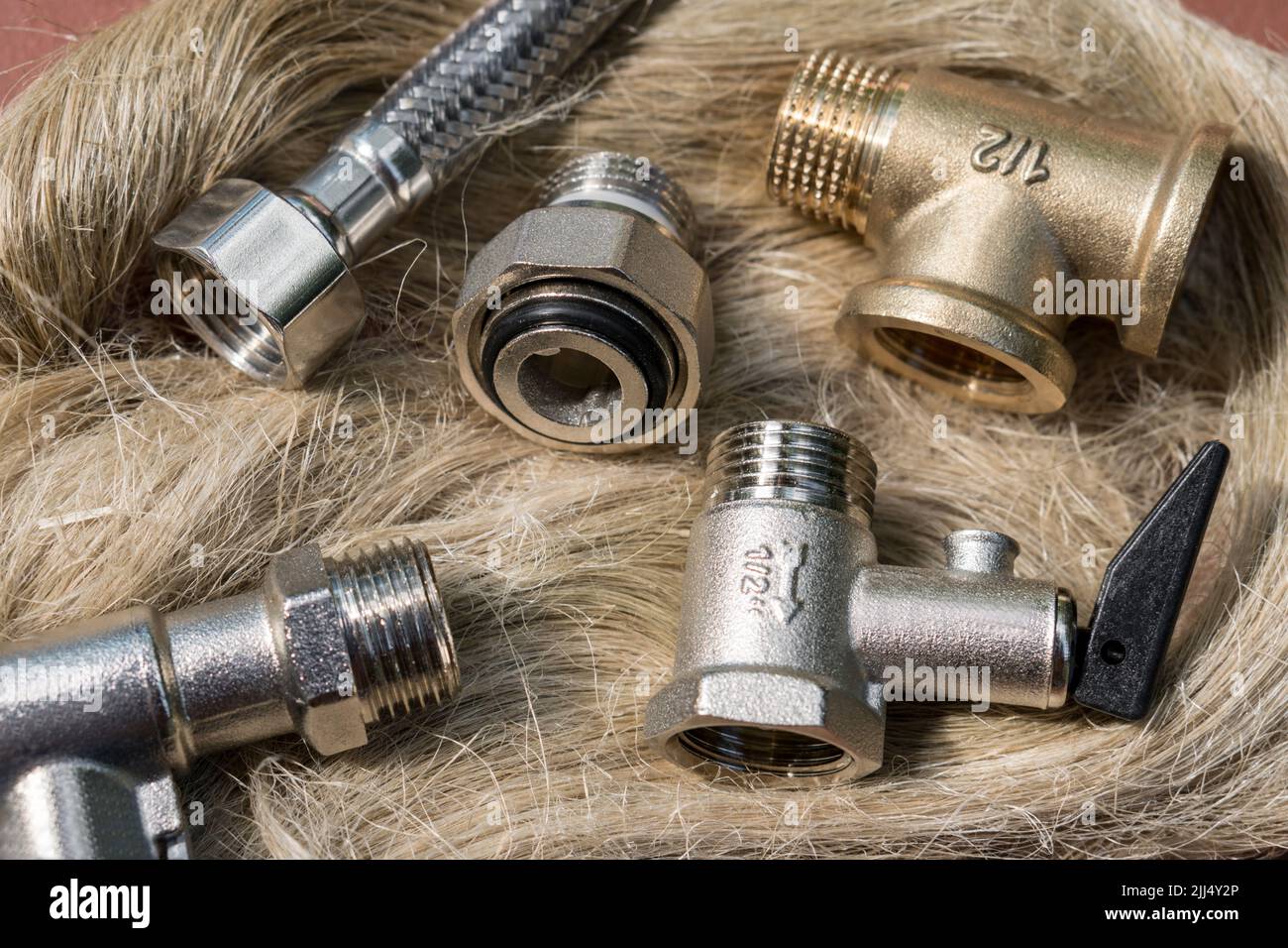 Set of plumbing equipment on a skein of tow. Plumbing industry concept Stock Photo