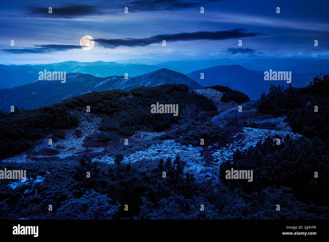 mountain landscape in autumn at night. wonderful nature scenery in full moon light. stones and plants on the hills. svydovets ridge of carpathian moun Stock Photo