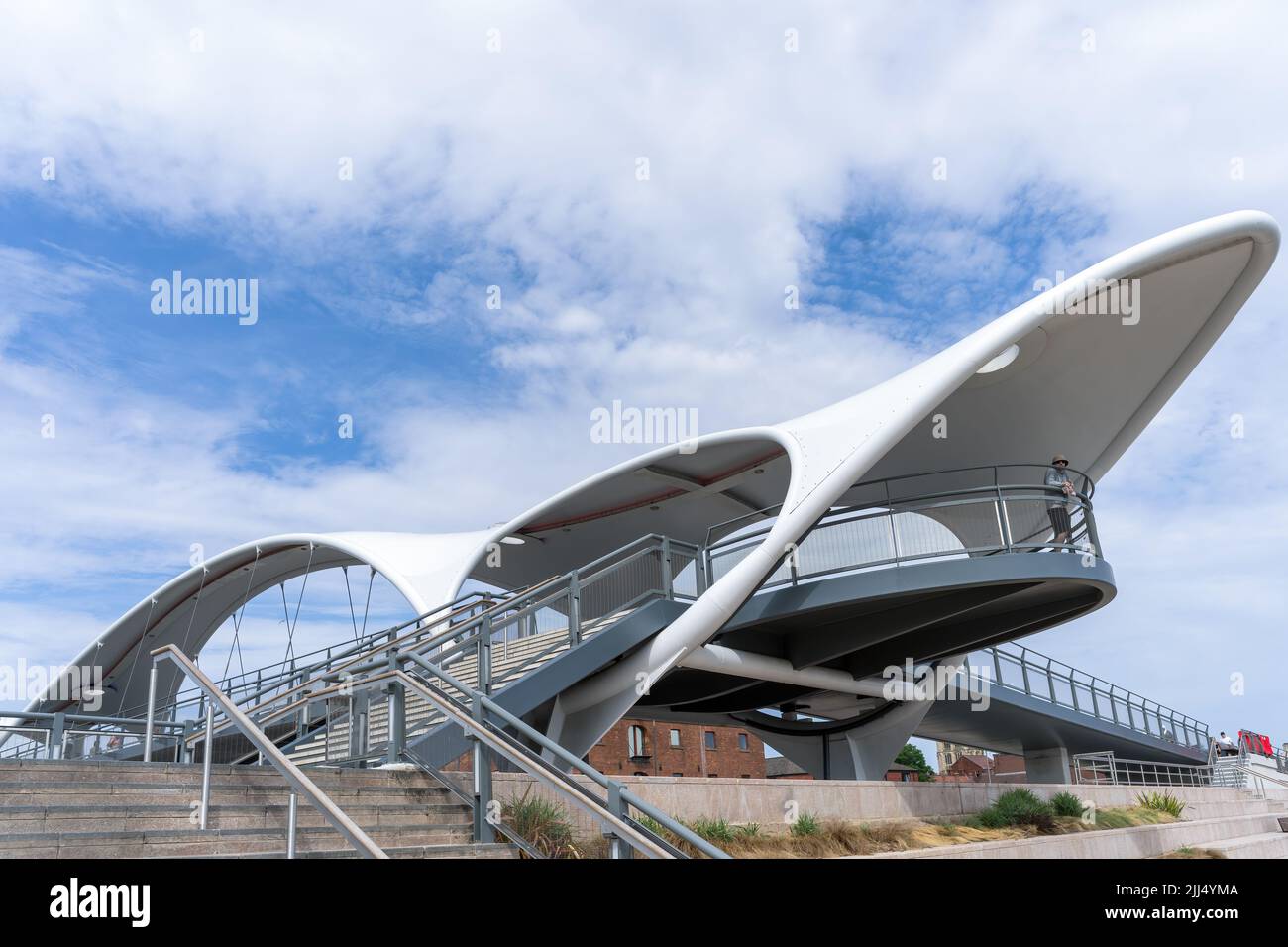 KINGSTON UPON HULL,  YORKSHIRE, UK - JULY 17: Murdoch's Connection footbridge by the marina in Kingston upon Hull on July 17, 2022. Three unidentified Stock Photo