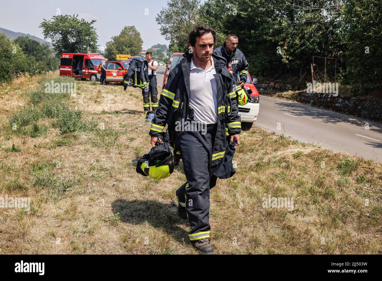 Firemen arrive on the scene of a rapidly advancing wildfire that burns ...