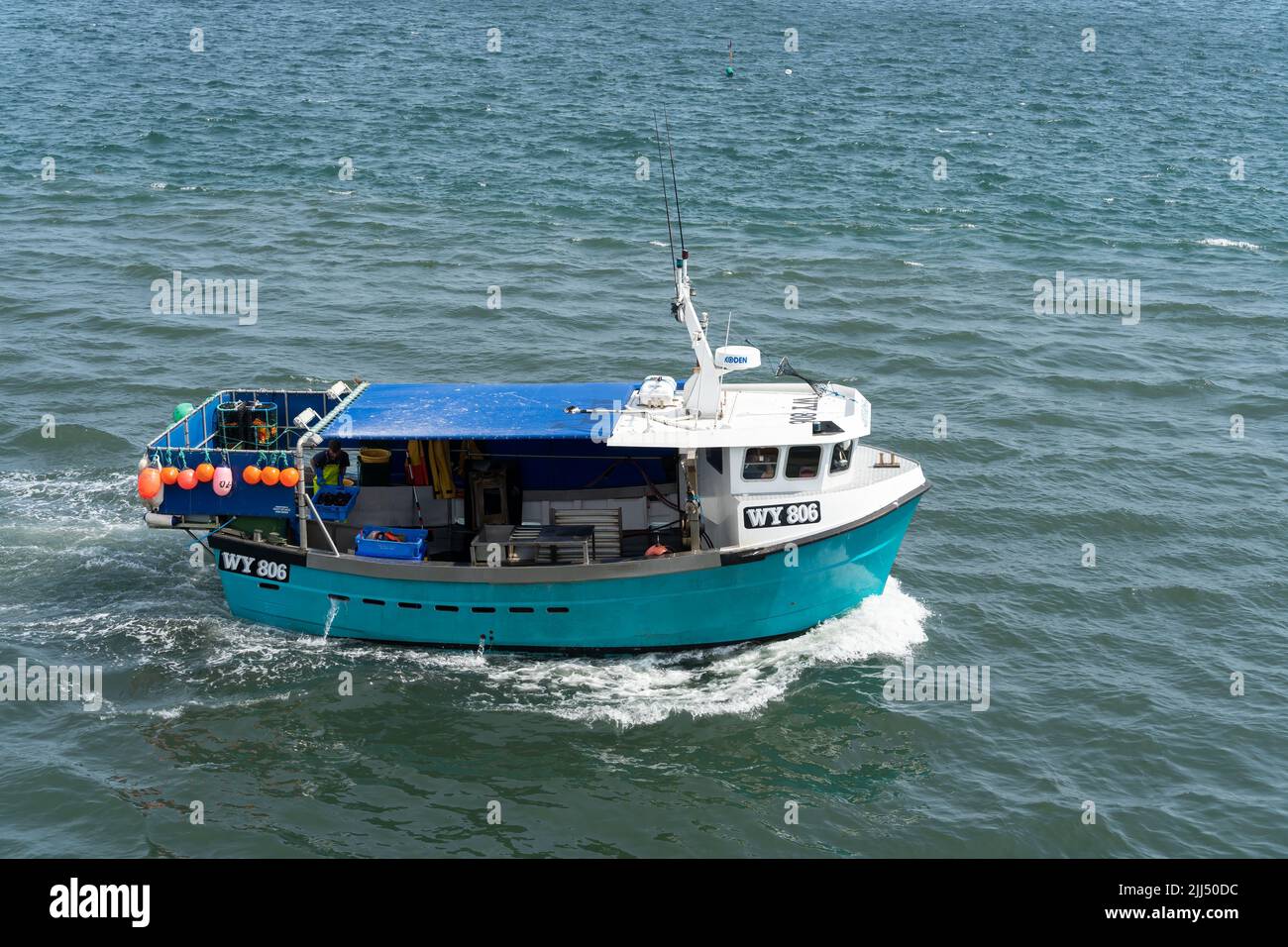 WHITBY,  NORTH YORKSHIRE, UK - JULY 19: Fshing boat heading towards Whitby, North Yorkshire on July 19, 2022. One unidentified person Stock Photo