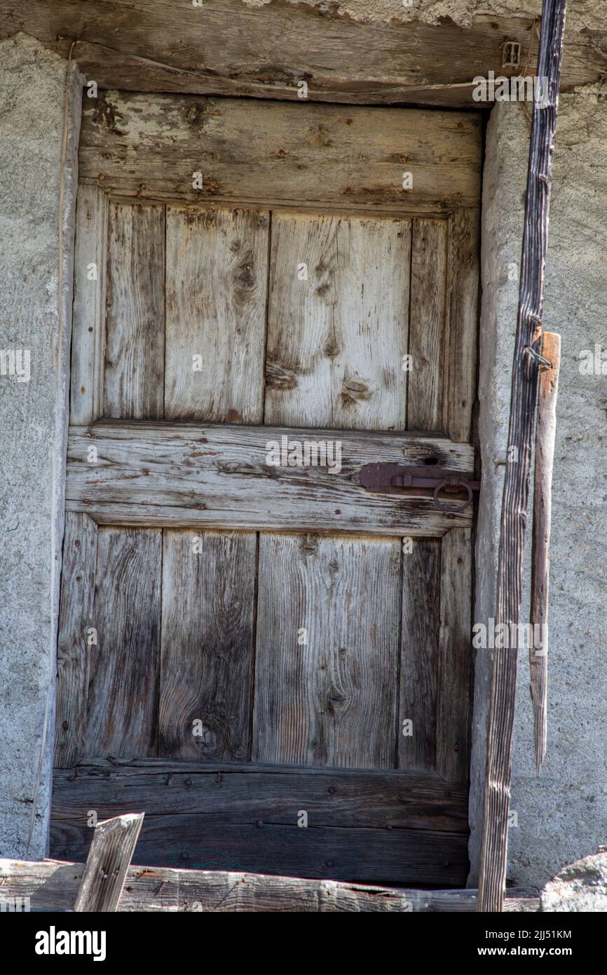 a beautifully old characteristic wooden door detail, Albosaggia, SO, Valtellina, Italy, Europe Stock Photo