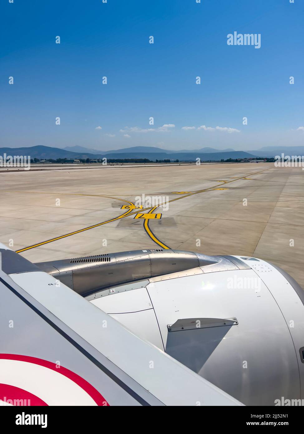 Airplane moving on airport tarmac towards takeoff airfield. No people. Aviation travel background with copy space. Sunny daylight Stock Photo
