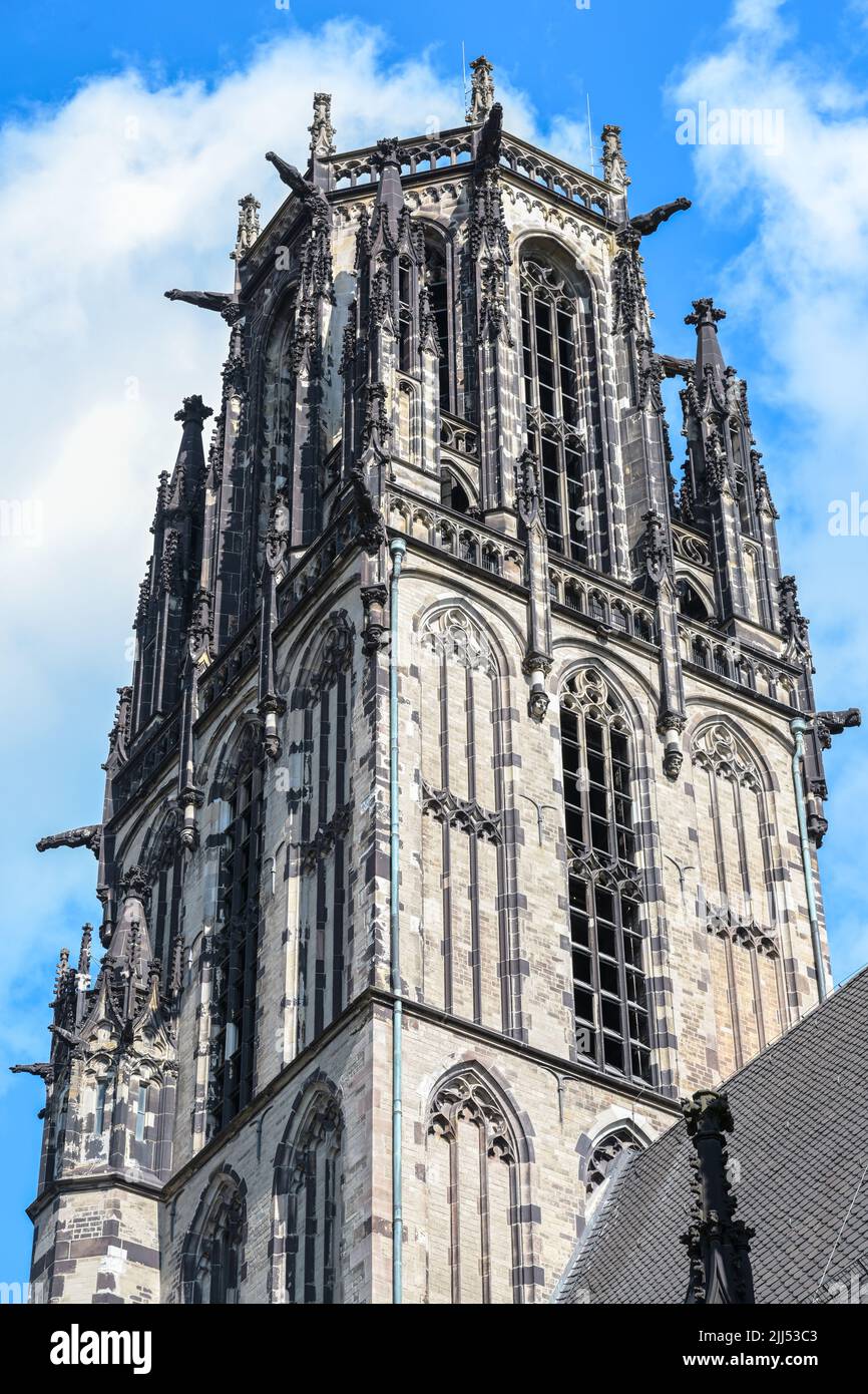 St. Salvator Church in Duisburg, part of the tower, the Gothic basilica from tuff stone is today a Protestant city church, blue sky with white clouds, Stock Photo