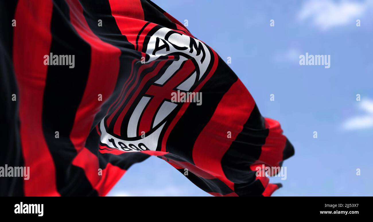 Milan, Italy, July 2022: The flag of A.C. Milan waving in the wind on a clear day. Milan is a professional football club based in Milan, Italy Stock Photo