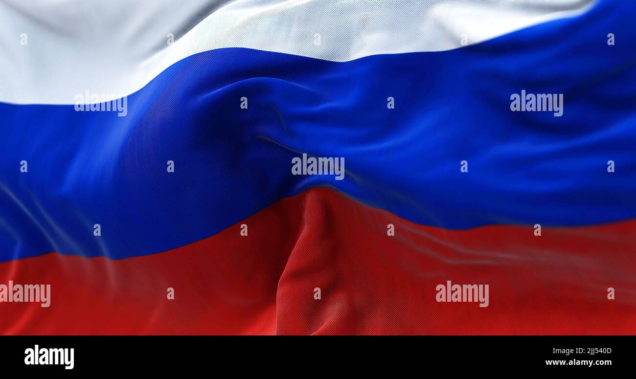 Close-up view of the Russian national flag waving in the wind. Russia is a transcontinental country spanning Eastern Europe and Northern Asia Stock Photo