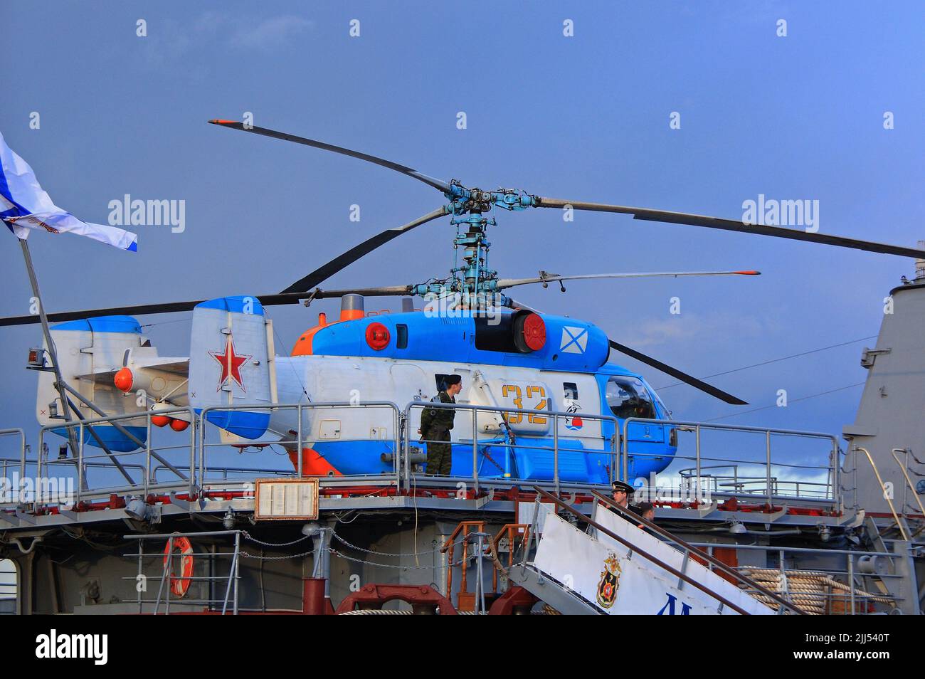 SEVASTOPOL, RUSSIA - July 30, 2021 Cruiser Moskva and new generation Russian reconnaissance and attack helicopter K-52 at Russian Navy Day.jpg Stock Photo