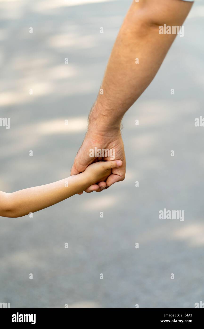 father and daughter walk on street hold hand Stock Photo - Alamy