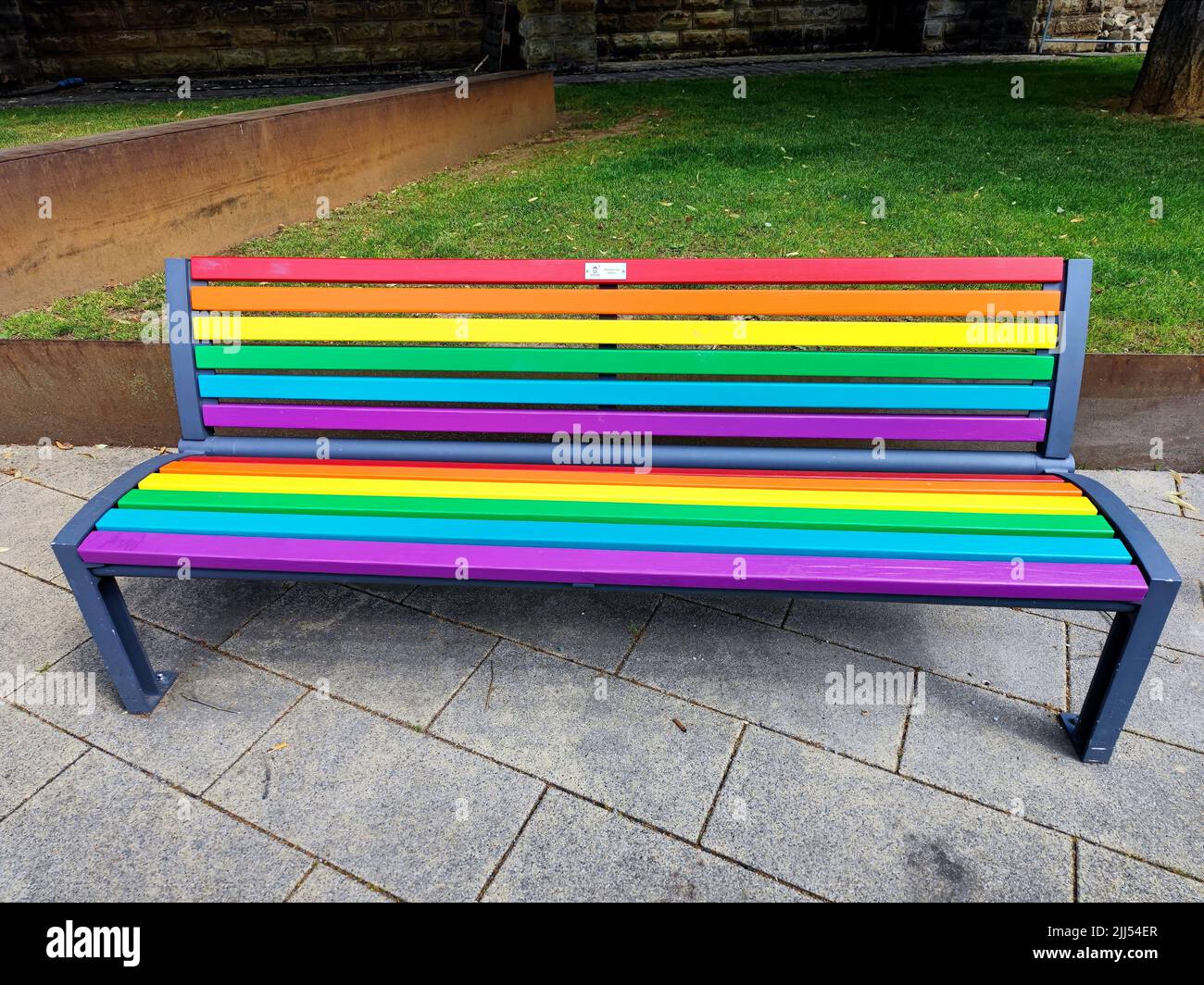 Front view of a rainbow bench in Dudelange, Luxembourg, Europe during LGBTQIA pride month Stock Photo
