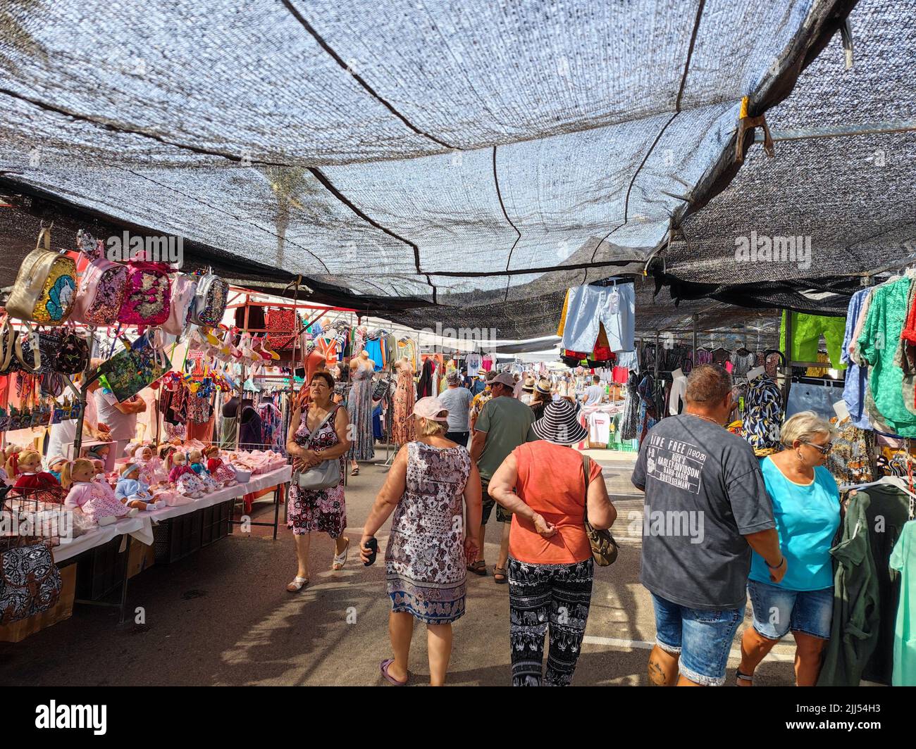 People shopping at the street market in Empuriabrava Gerona Spain (Catalonia). Tourists are able to visit the market again after the corona pandemic Stock Photo