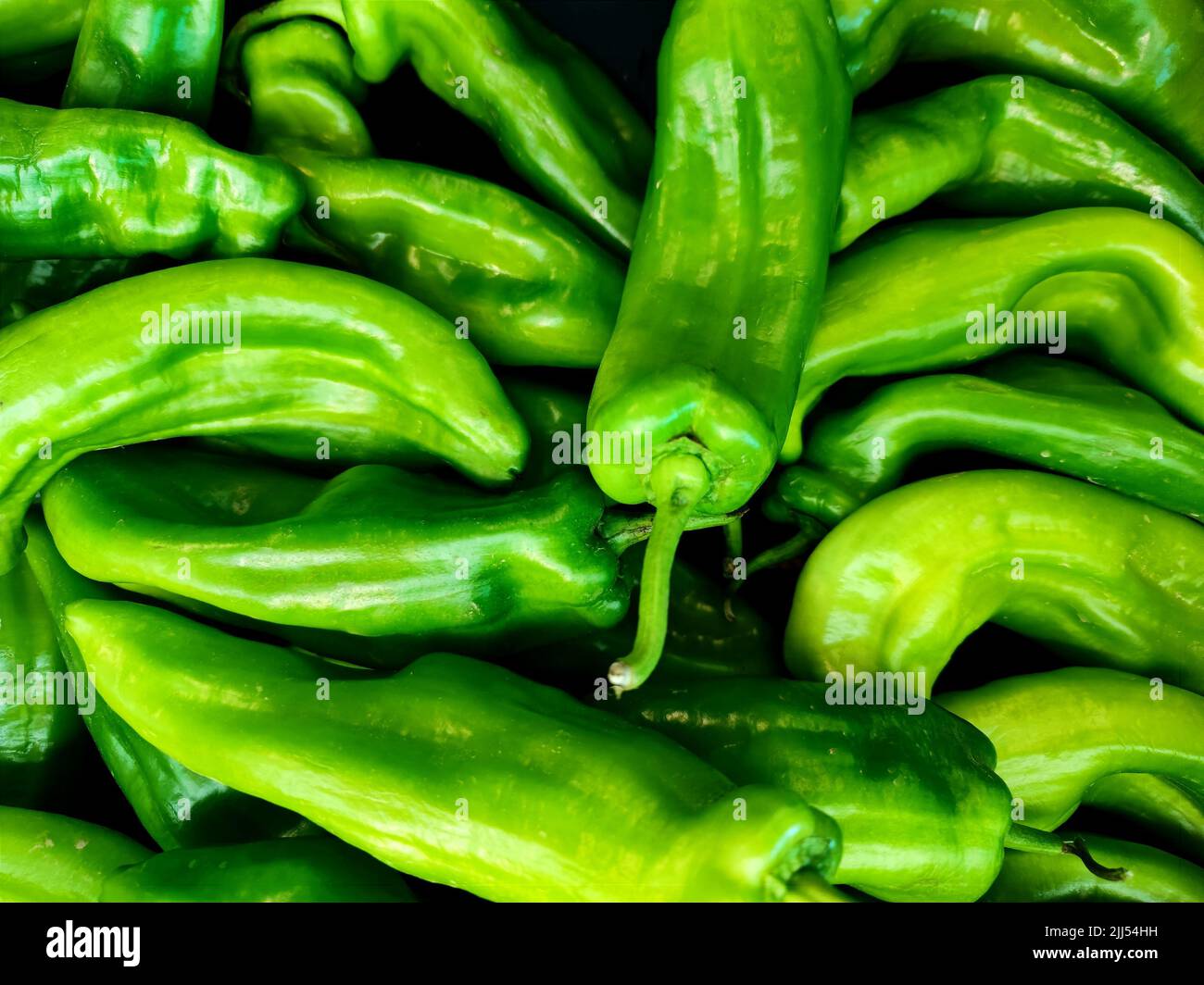 Pile of green peppers with black background. Great shot for restaurants, markets and designers. Stock Photo