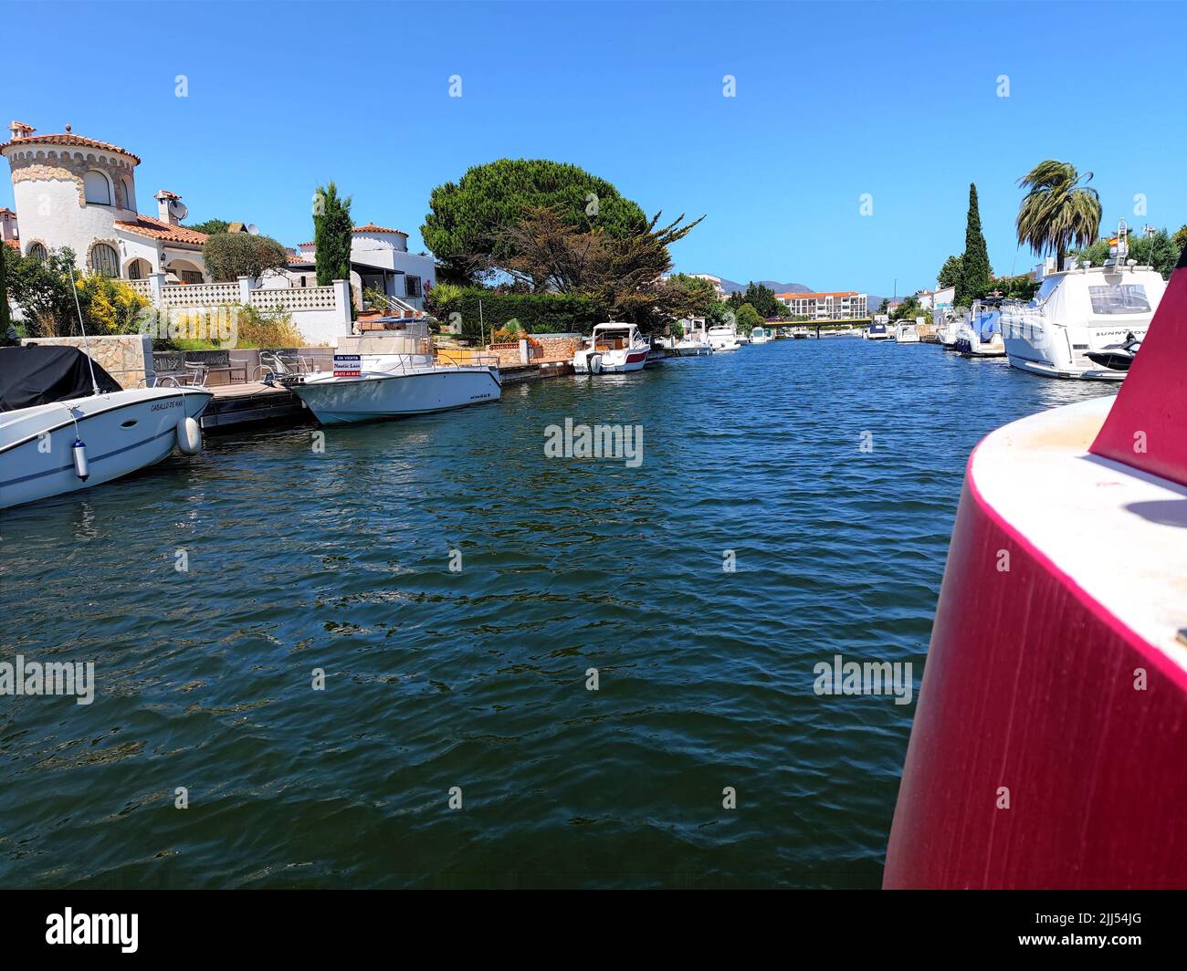 Empuriabrava, Spain. Beautiful channels with beautiful boats at the largest residential marina of Europe. Shot taken from boat view. Stock Photo
