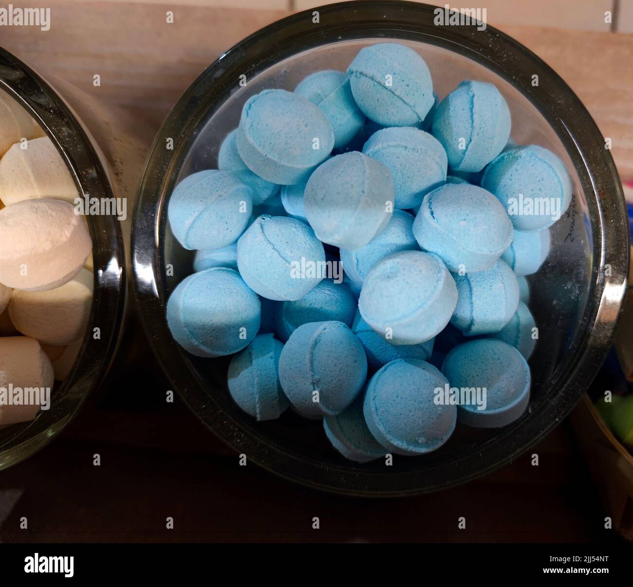 Blue unmarked bath bombs in a jar. There are no people or trademarks in the shot. Stock Photo