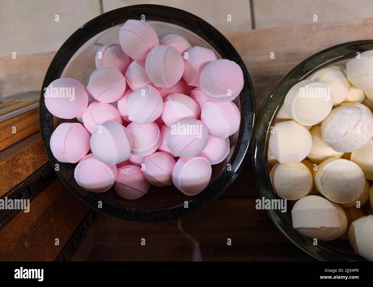 Pink unmarked bath bombs in a jar. There are no people or trademarks in the shot. Stock Photo