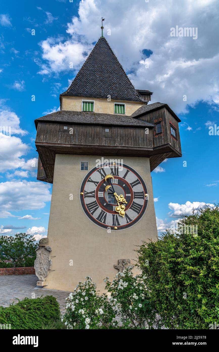 Beautiful of the clock tower on top of the Castle Hill (Schlossberg) on a sunny summer day with blue sky and cloud in background, Graz, Austria Stock Photo