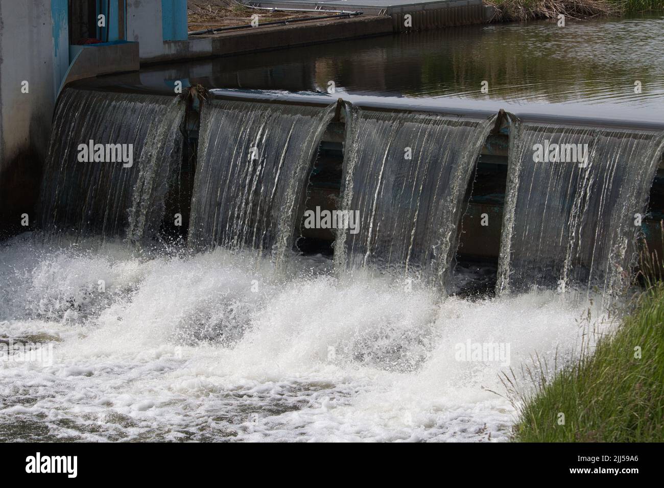 River water flowing over a weir Stock Photo